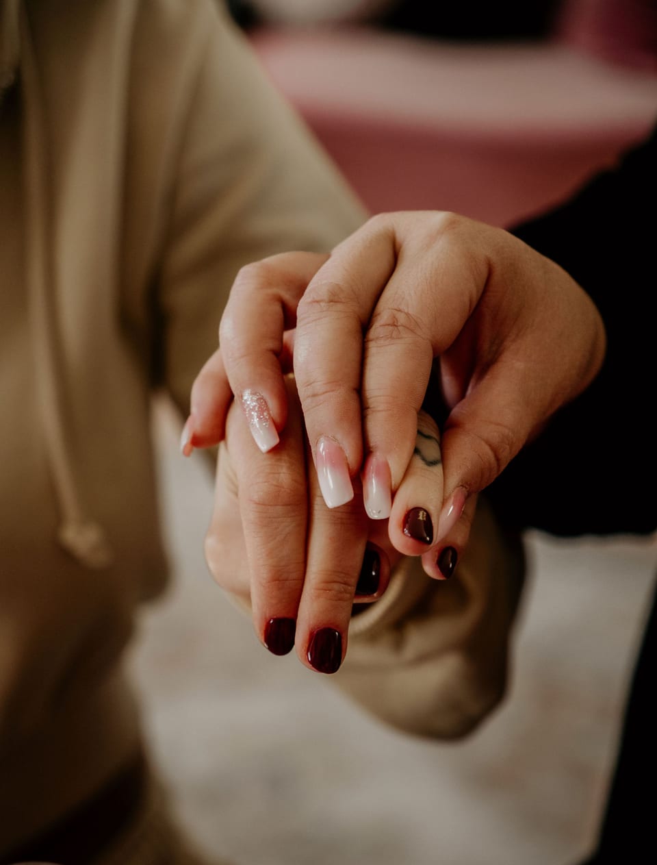 Close-up of the couple's hands and wedding rings.