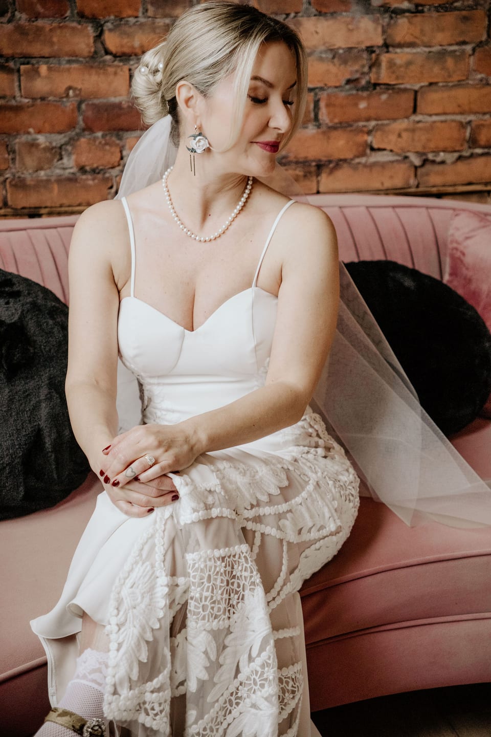 Relaxed portrait of the bride on a couch before the ceremony.
